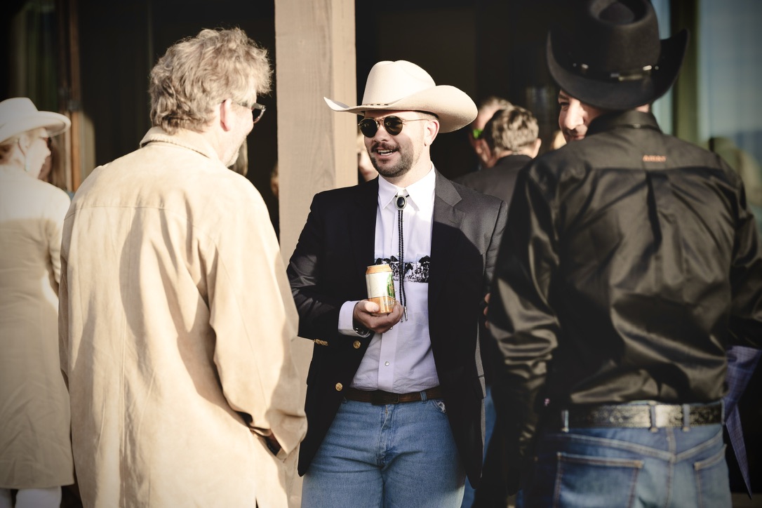 Kyle Self in conversation, cowboy hat and bolo tie